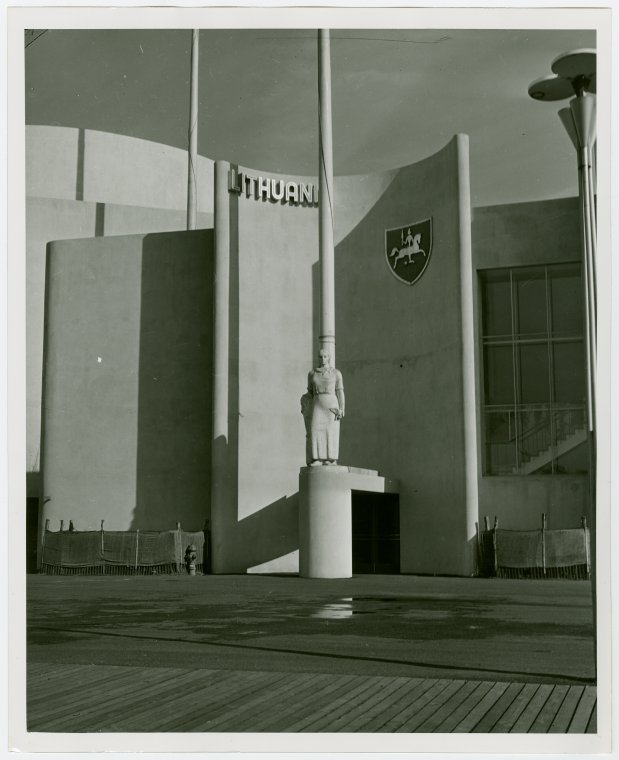 Image of the Lithuanian pavilion with statue of a country girl and coat of arms